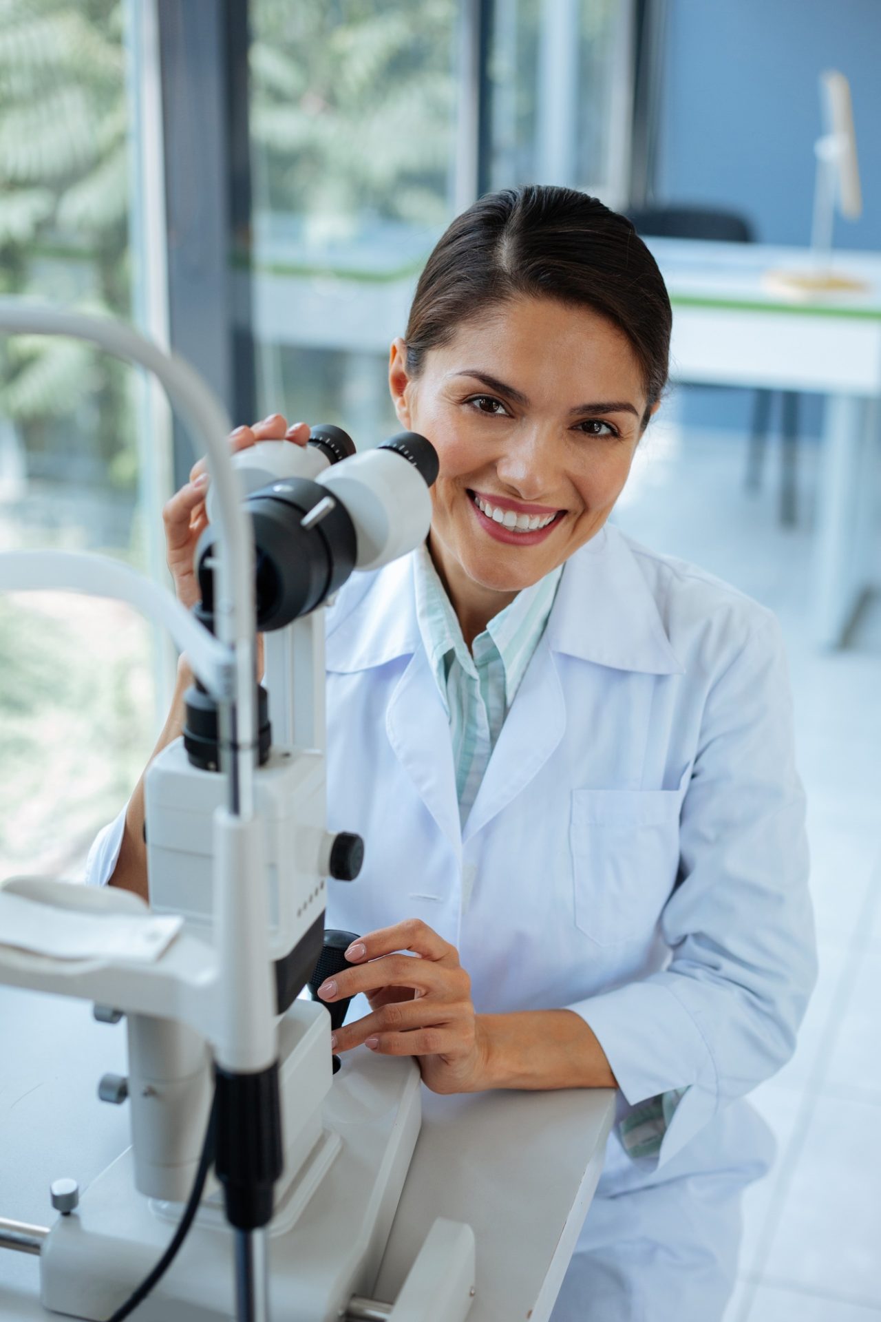 Happy positive woman being at work in the clinic